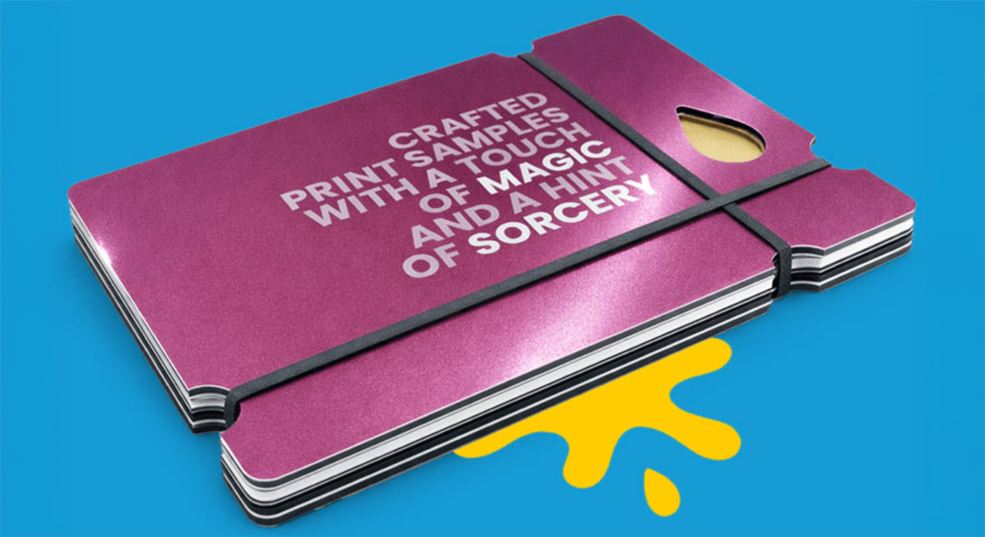 Stack of purple print samples with white text, held by a black band on a blue background.