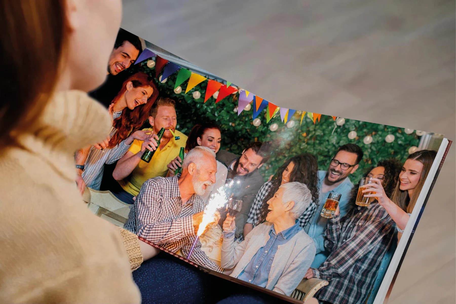 A woman enjoy a photo book featuring images from a family gathering
