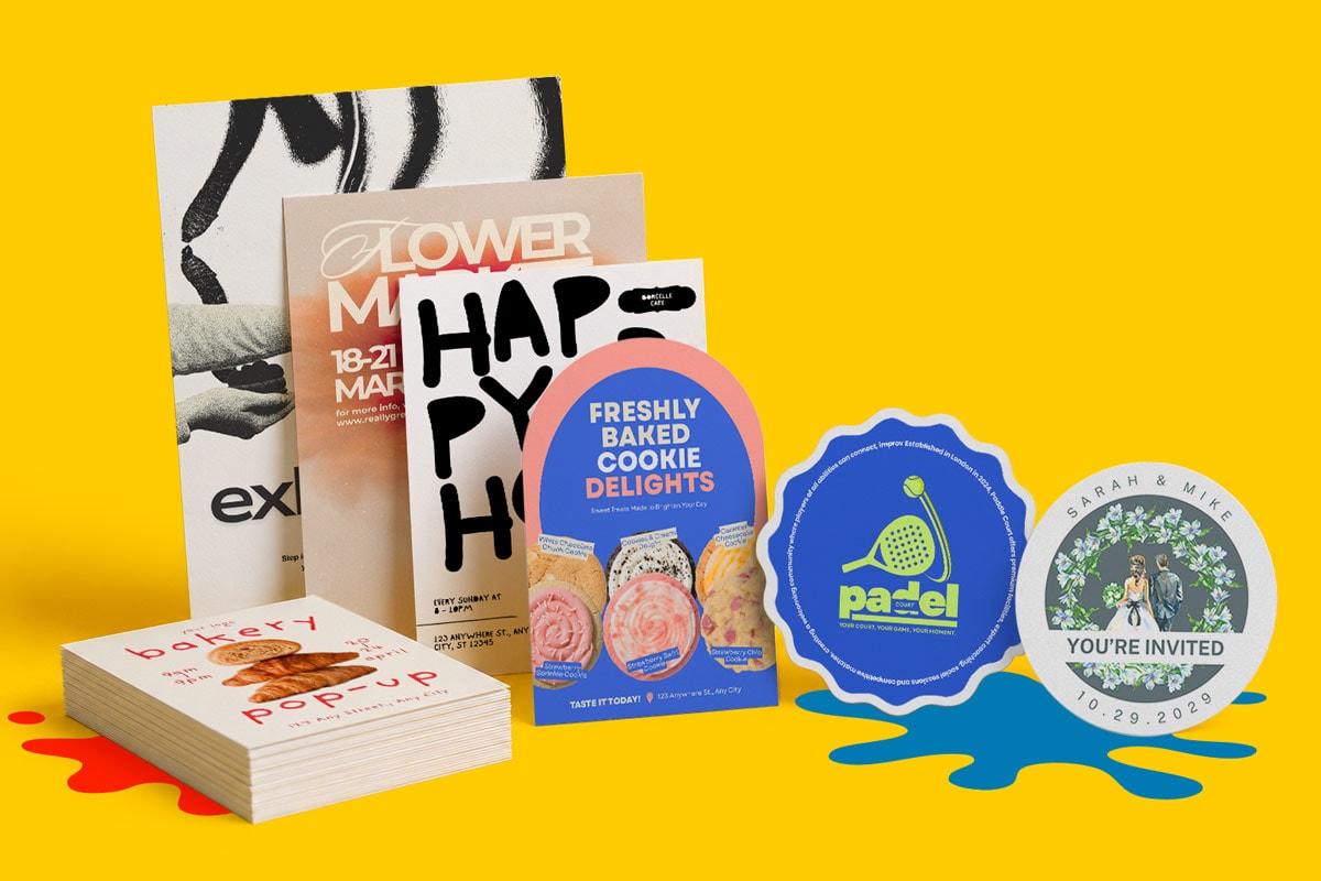 Assorted white paper flyers and colourful custom shapes invitations arranged on a yellow background.