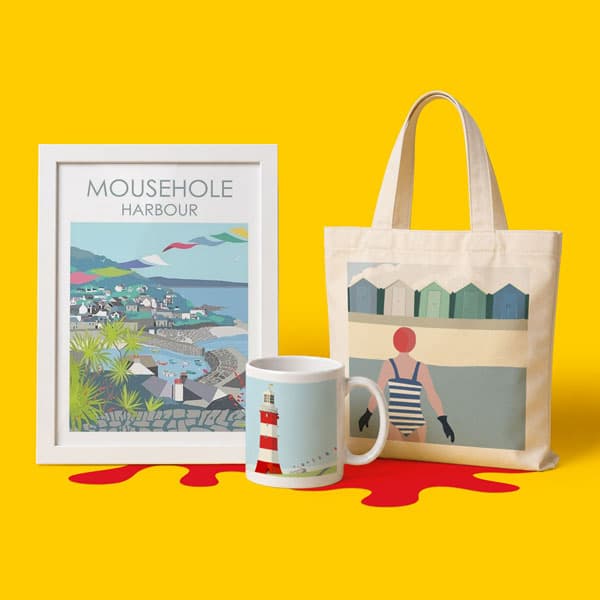 Framed Mousehole Harbour print, seaside mug, and tote bag on yellow background.