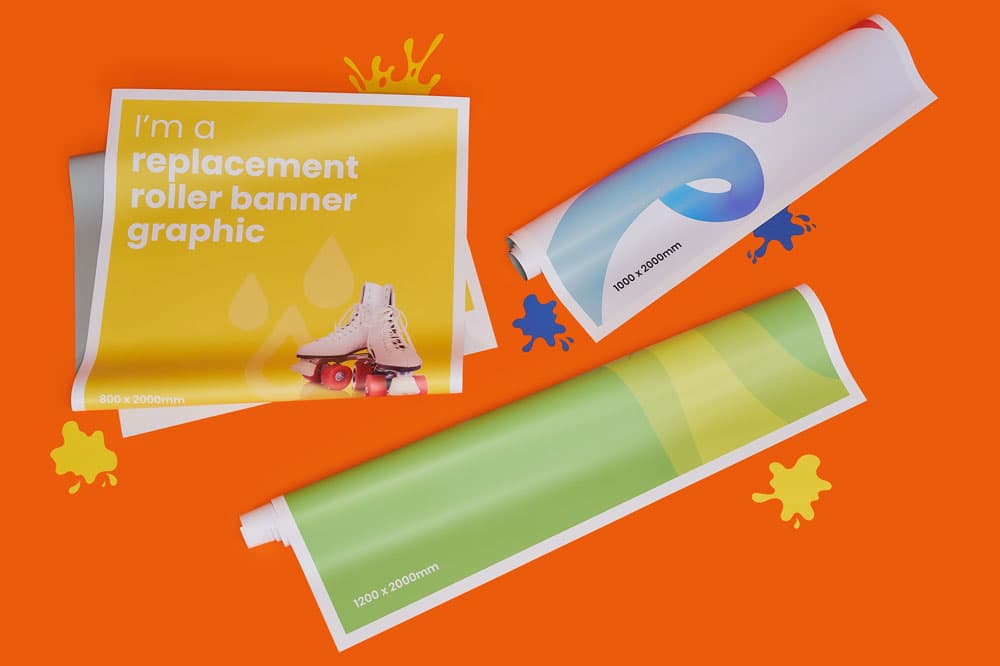 Three rolled banner graphics on an orange surface with paint splatters and measurements shown.