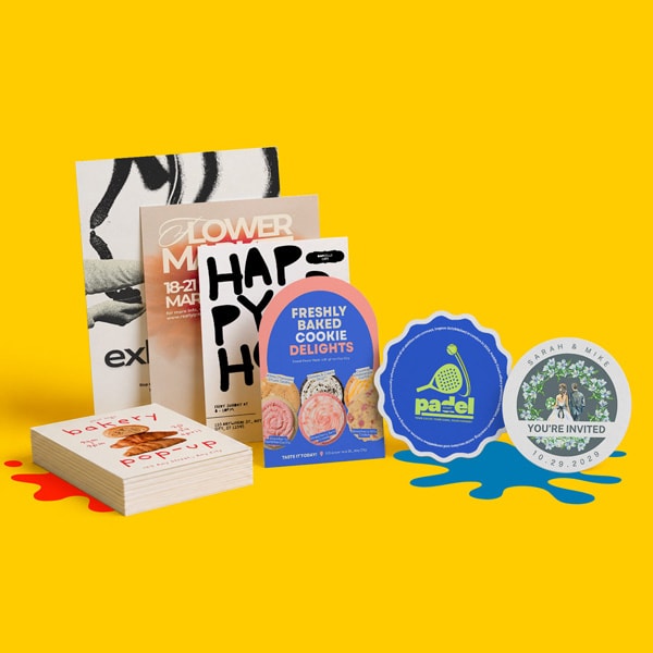Assorted flyers and stickers are displayed upright and stacked on a yellow background.