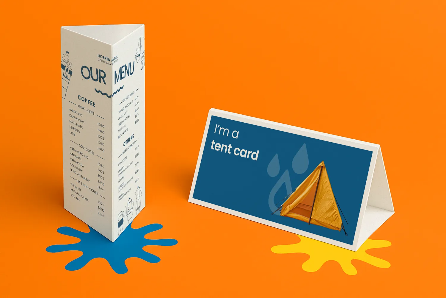 Coffee menu tent card and blue tent card on orange surface with paint splatters.