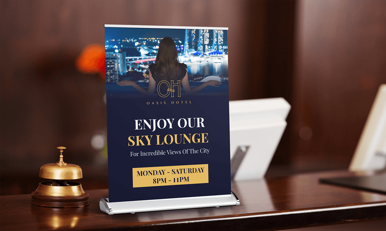 Desktop Roller Banner on hotel counter advertising Oasis Hotel Sky Lounge, open Monday-Saturday, 8PM-11PM.