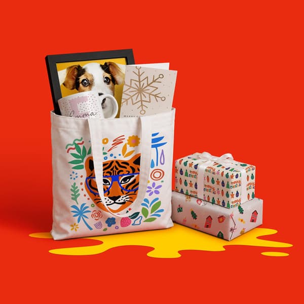 Tote bag with tiger print holds gifts; two wrapped presents sit beside it on a red background.