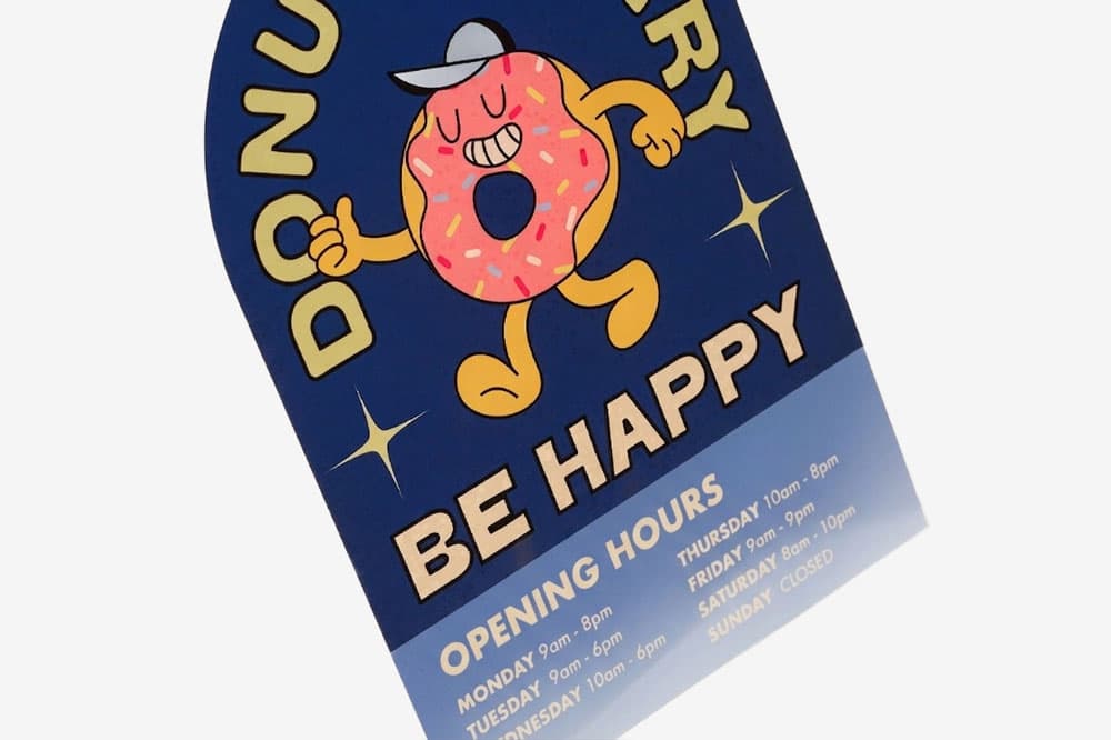 Donut shop sign with a cartoon donut and opening hours listed for each day of the week.