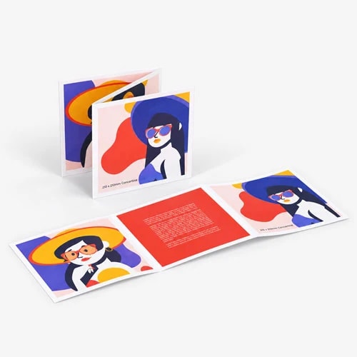 Folded brochure with colourful illustrations of people wearing sunglasses and hats on a gray surface.