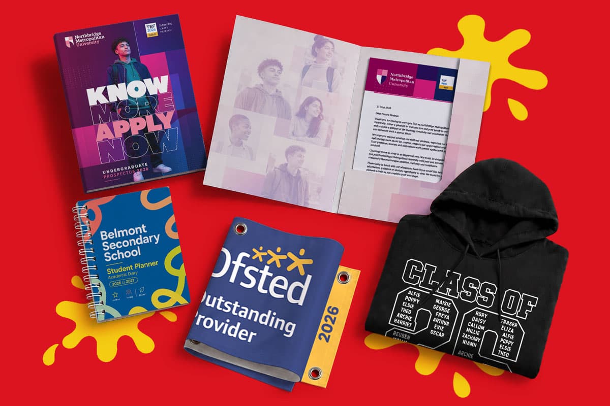 A variety of school-themed items including brochures, a notebook, a hoodie, and a banner.