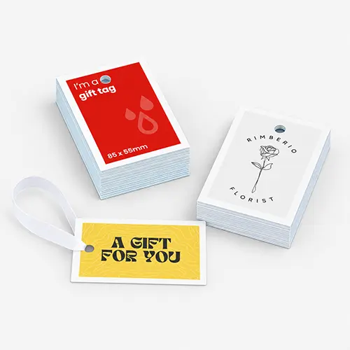 Three stacks of rectangular gift tags with various designs and text.