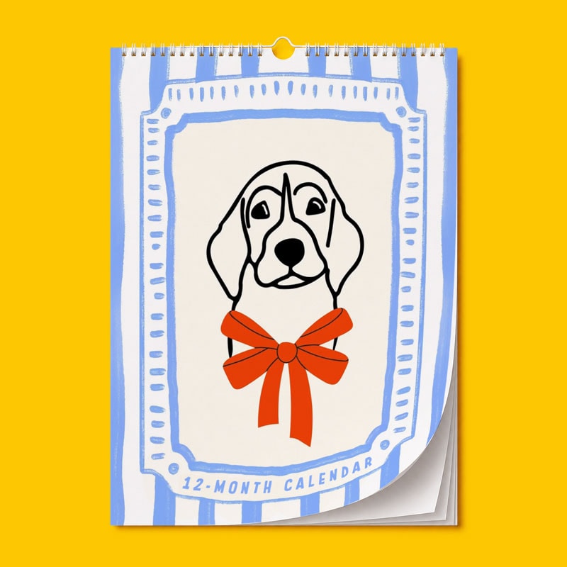 Illustrated dog with a red bow on a 12-month calendar against a yellow background.