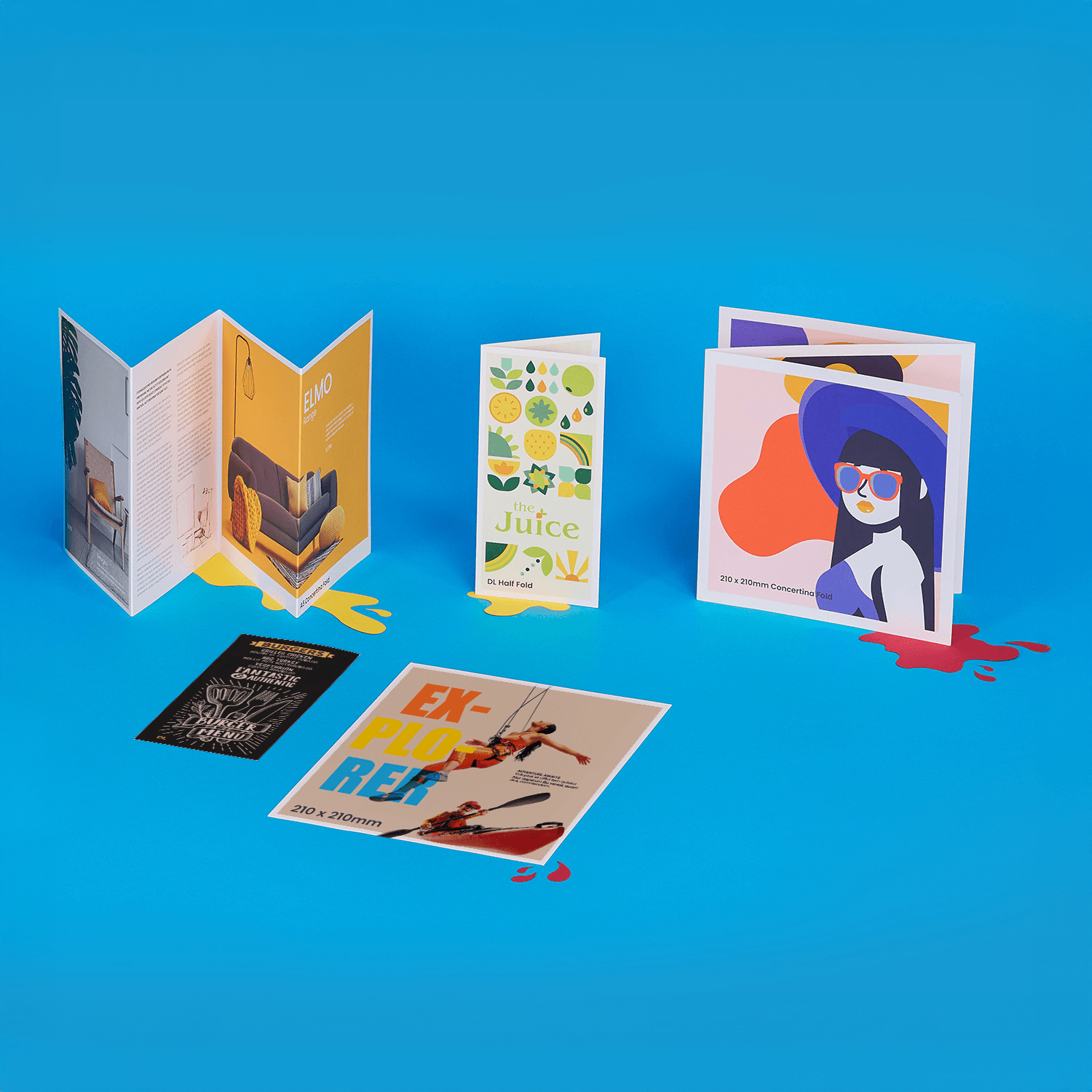 Various colourful printed brochures and flyers displayed on a bright blue surface.