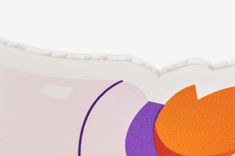 Close-up of a colorful, abstract design on a curved, white, textured surface.