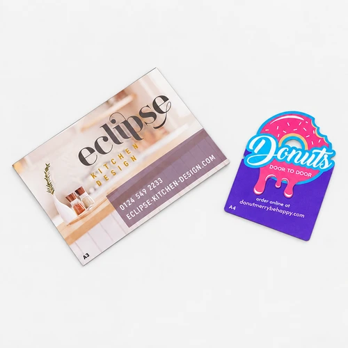 Two business cards: one for Eclipse Kitchen Design, one for Donuts Door To Door.