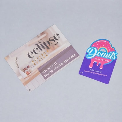 Two business cards: one for Eclipse Kitchen Design, one for Donuts Door To Door.