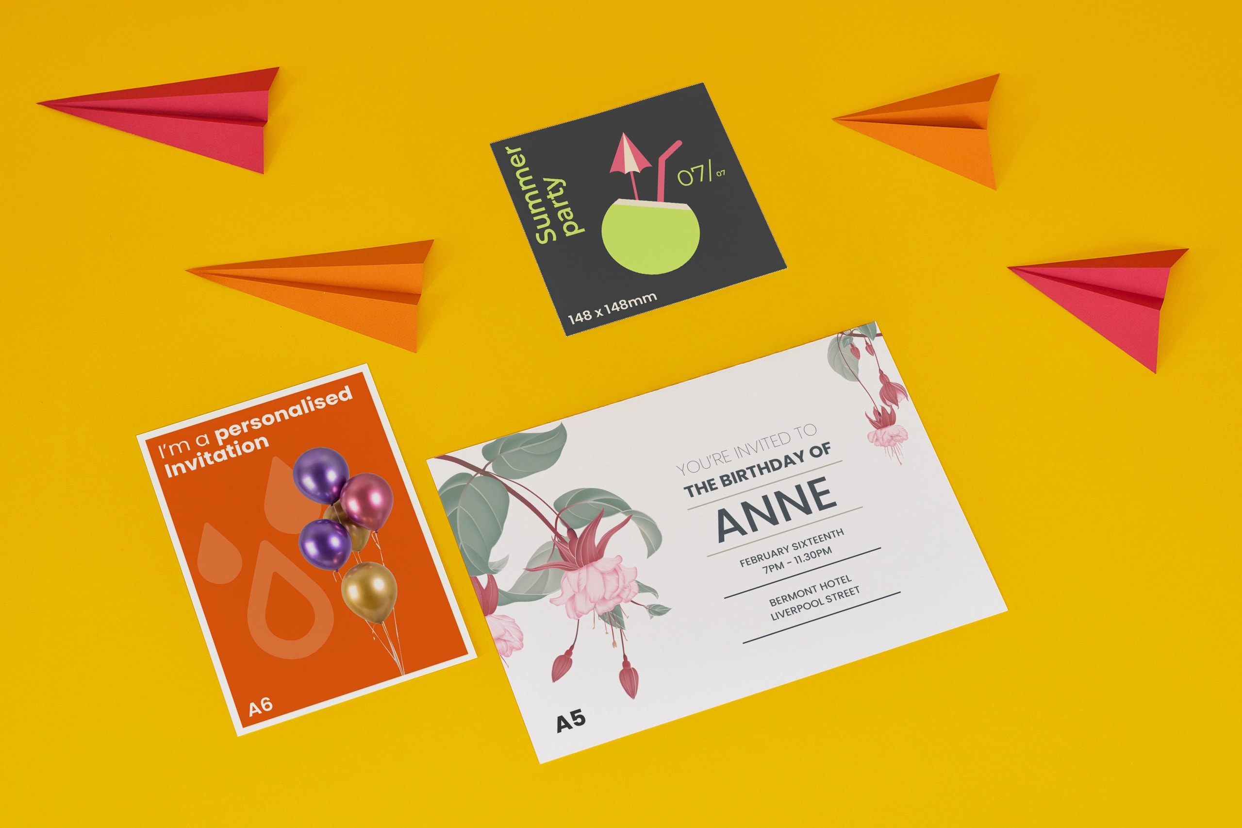 Four printed cards and paper planes on a yellow background.