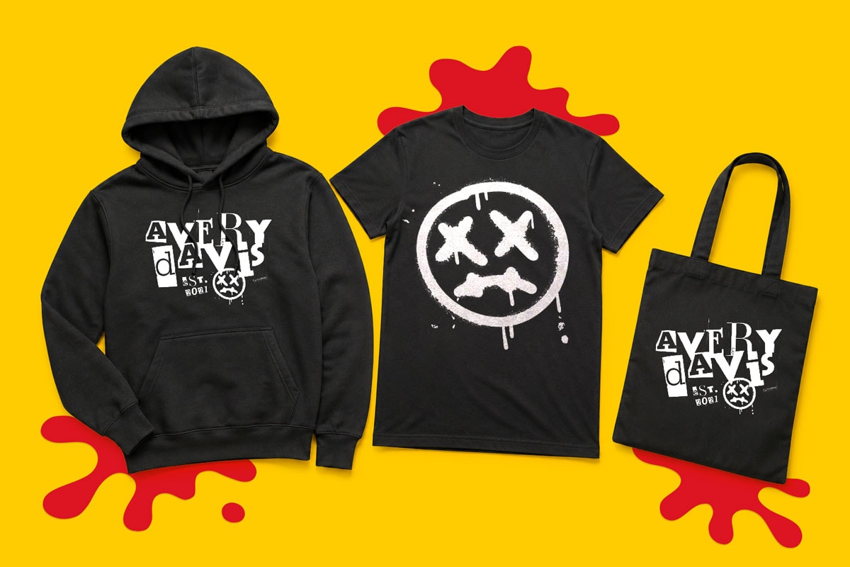 Black hoodie, t-shirt, and tote bag with bold white graphics on a yellow background.