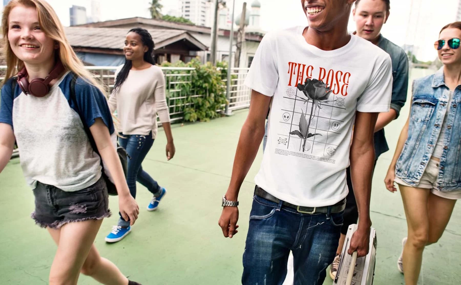 A group of young people walking together, featuring a man in a modern, sleek organic t-shirt