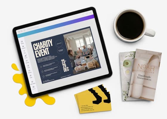 Tablet displaying a charity event flyer, beside a coffee cup, books, and business cards.