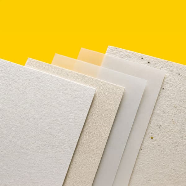 Five different textured and colored paper sheets are stacked against a bright yellow background.