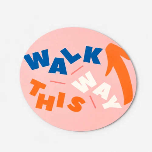 A pink circle floor sticker reads "WALK THIS WAY" with an arrow pointing to the upper right.
