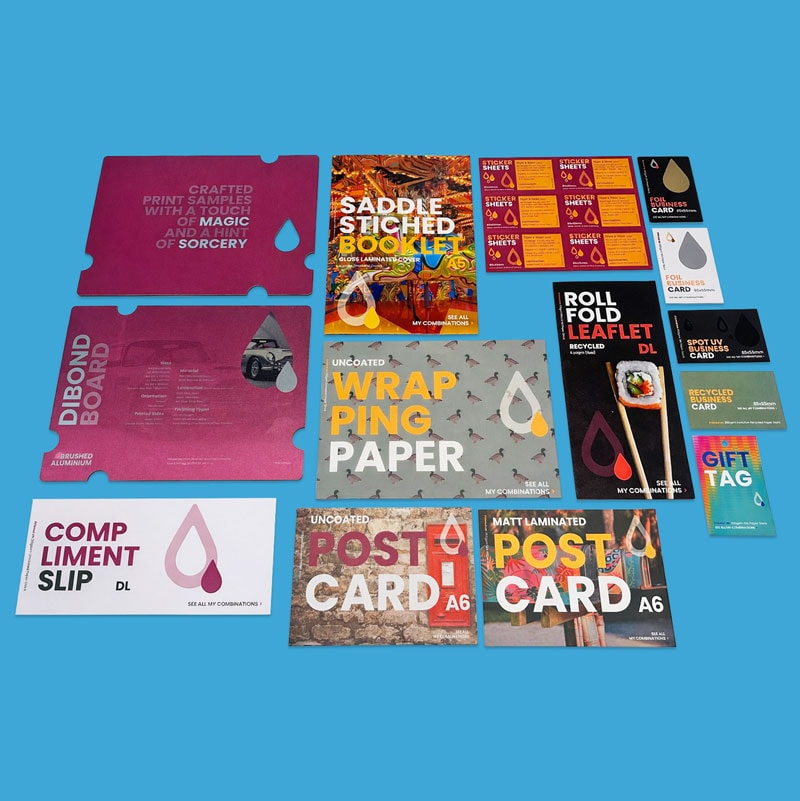 Assorted printed marketing materials and cards displayed on a solid blue background.