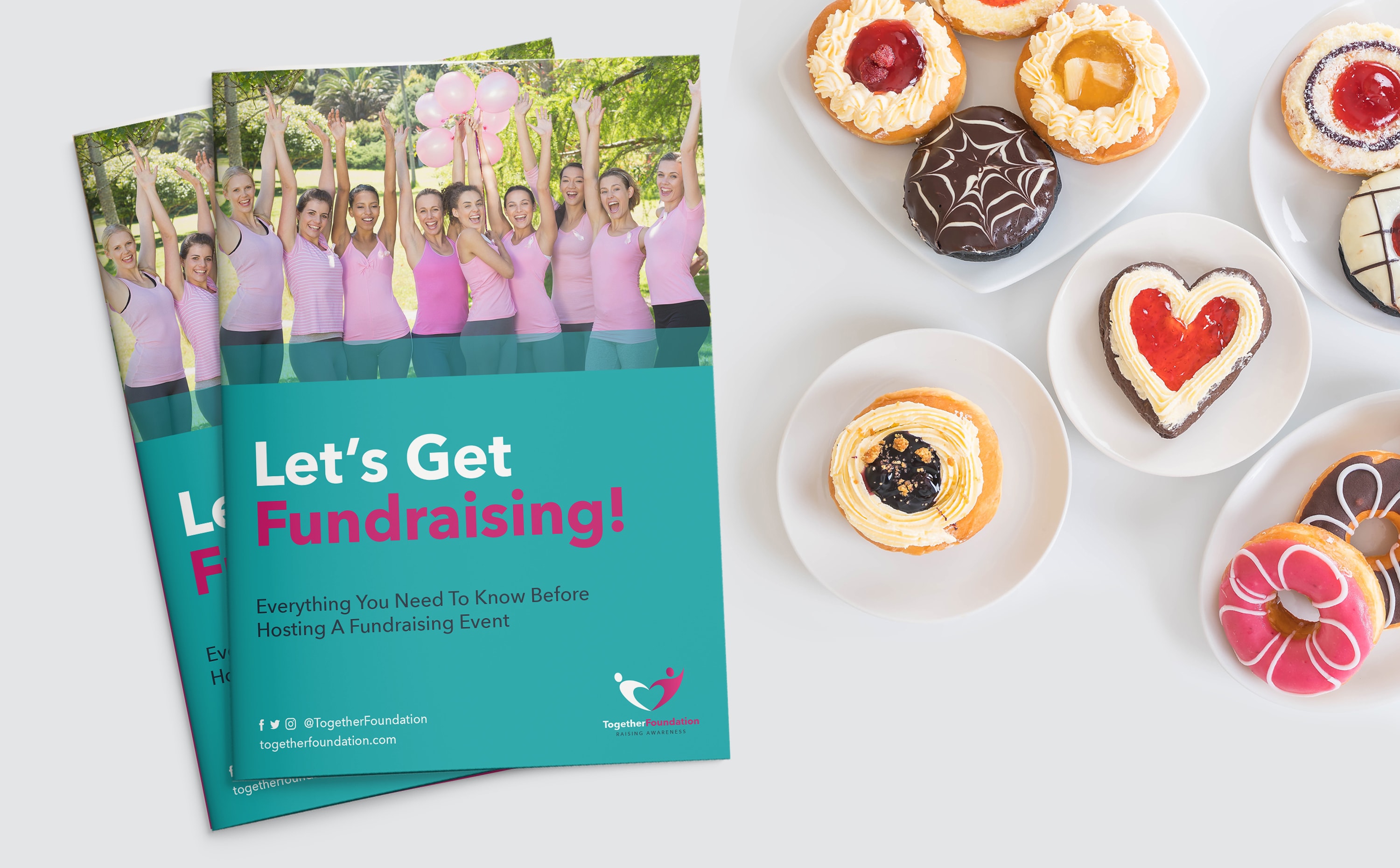 Two fundraising stitched books next to plates of assorted decorated pastries and donuts.