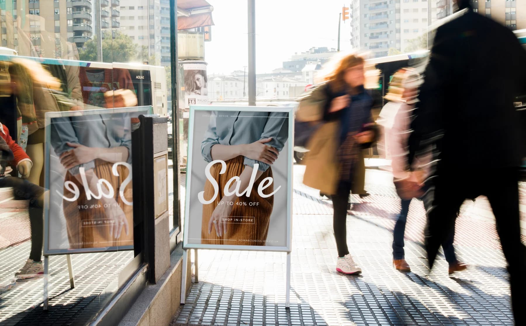 A bustling city scene with people walking by a prominent sale sign