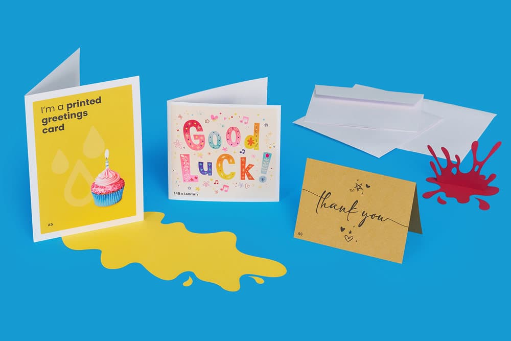 Three greeting cards with envelopes on a blue background.