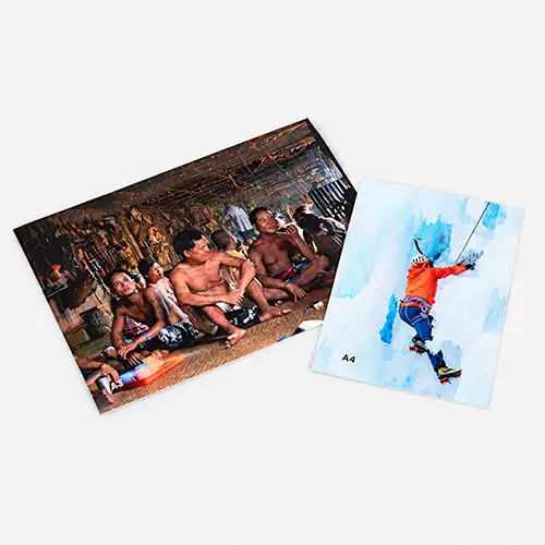 Two A4 prints: one of a group indoors, the other of a person climbing on ice.