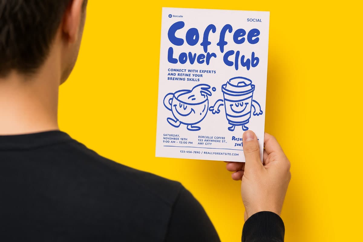 Person holding a Coffee Lover Club flyer with cartoon coffee cup illustrations on a yellow background.