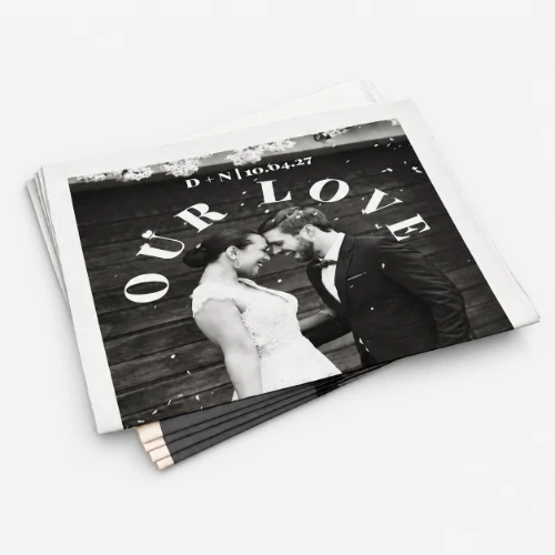 A black and white photo of a couple at their wedding with "OUR LOVE" written behind them.