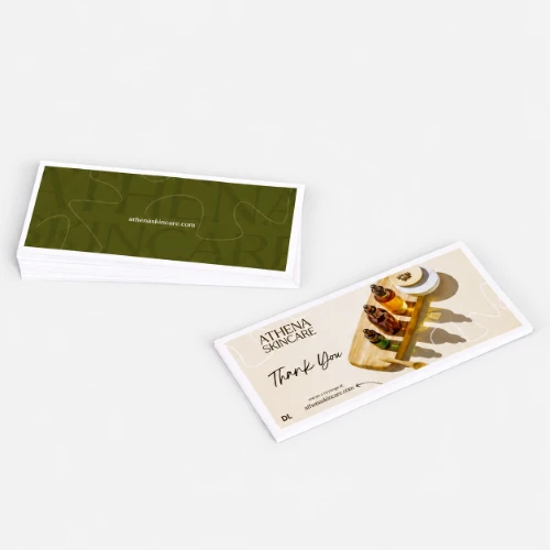 Two Athena Skincare compliment slips, one showing the front design, the other showing the back.