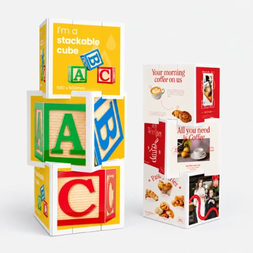 Two stackable display cube displays, one with alphabet blocks and one with coffee and pastry ads, side by side.