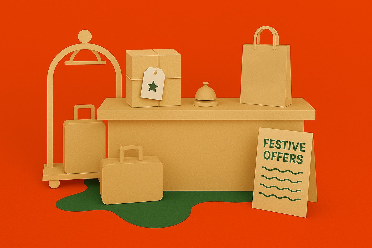 Cardboard luggage, packages, and a sign reading “Festive Offers” on an orange background.