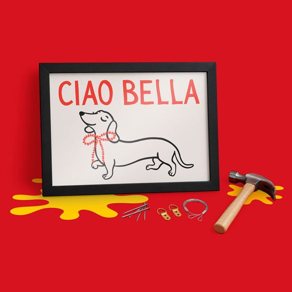 Framed “CIAO BELLA” dachshund print with hanging tools and hardware on red background.