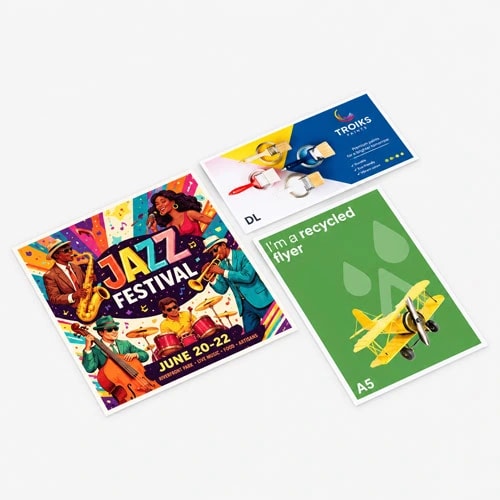 Three different printed flyers are laid out on a plain light gray surface.