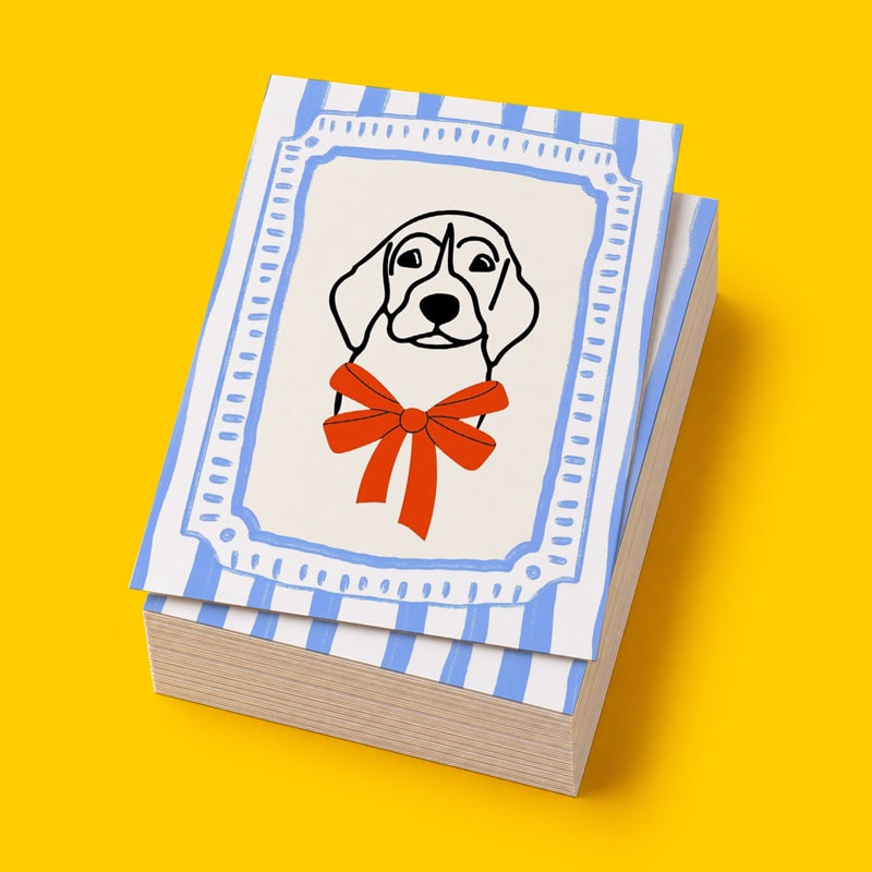Stack of cards with a dog illustration wearing a red bow, on a blue and white striped background.