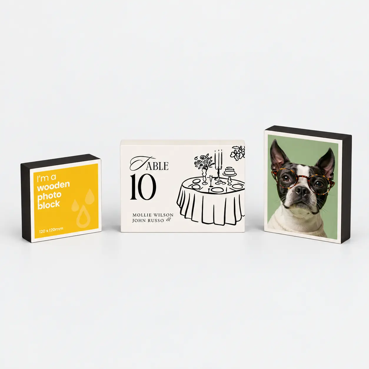 Three wooden photo blocks: a yellow informational block, a table number sign, and a dog portrait.