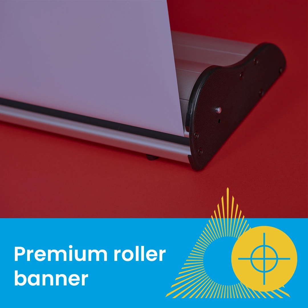Close-up of a premium roller banner base on a red background with graphic and text overlay.