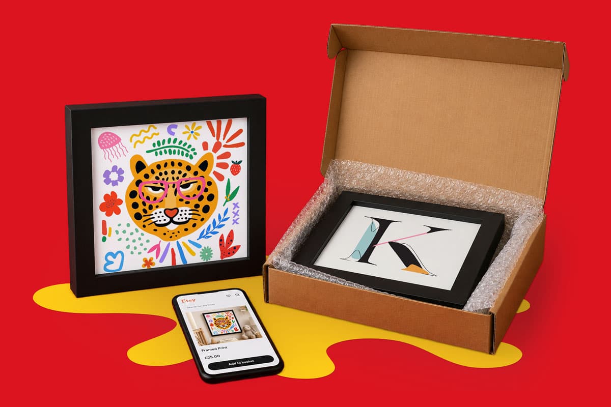 Framed art prints, a smartphone, and a box displayed on a red and yellow background.