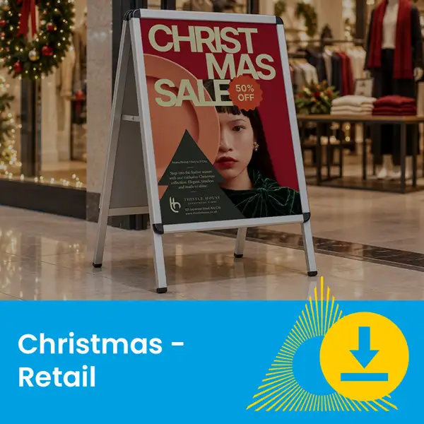 A Christmas sale sign stands in a mall corridor, advertising 50% off at a retail store.