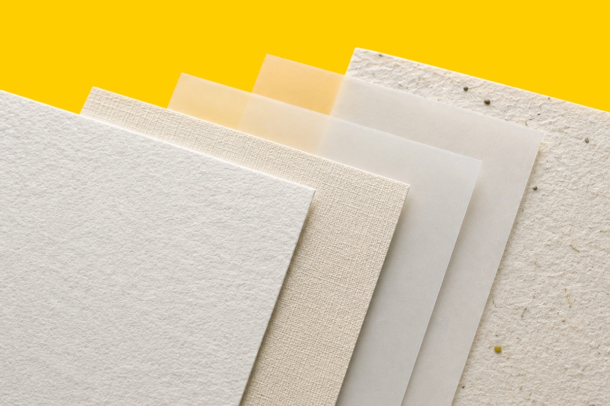 Five textured and translucent paper sheets arranged in a fan pattern on a yellow background.