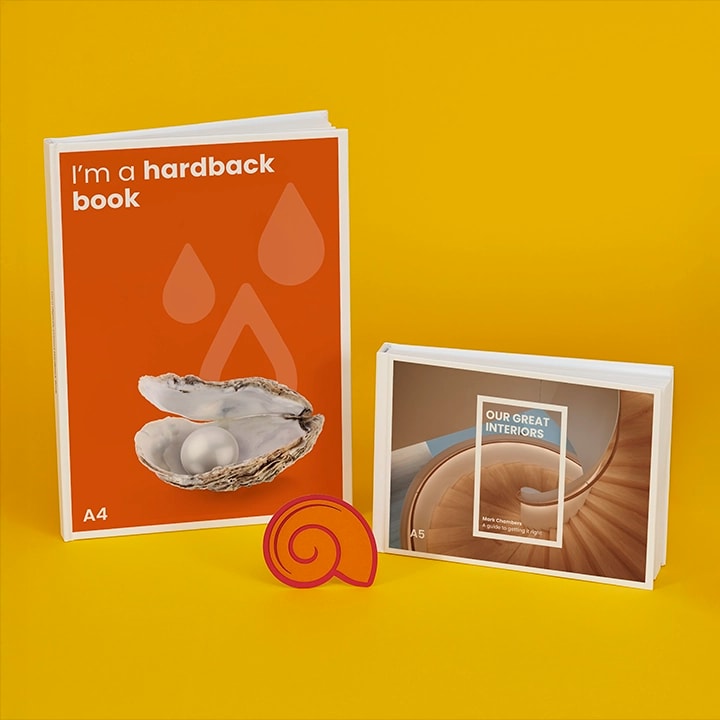 Two books, one hardback and one softcover, displayed upright against a yellow background.