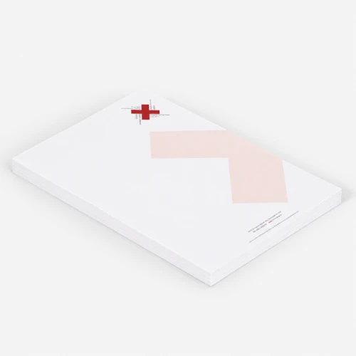 A stack of white letterhead paper with a red cross logo and geometric design in the corner.