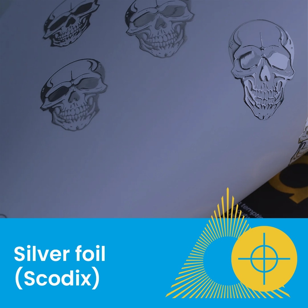 Sheet with silver foil skull designs, labeled "Silver foil (Scodix)" on a blue banner.