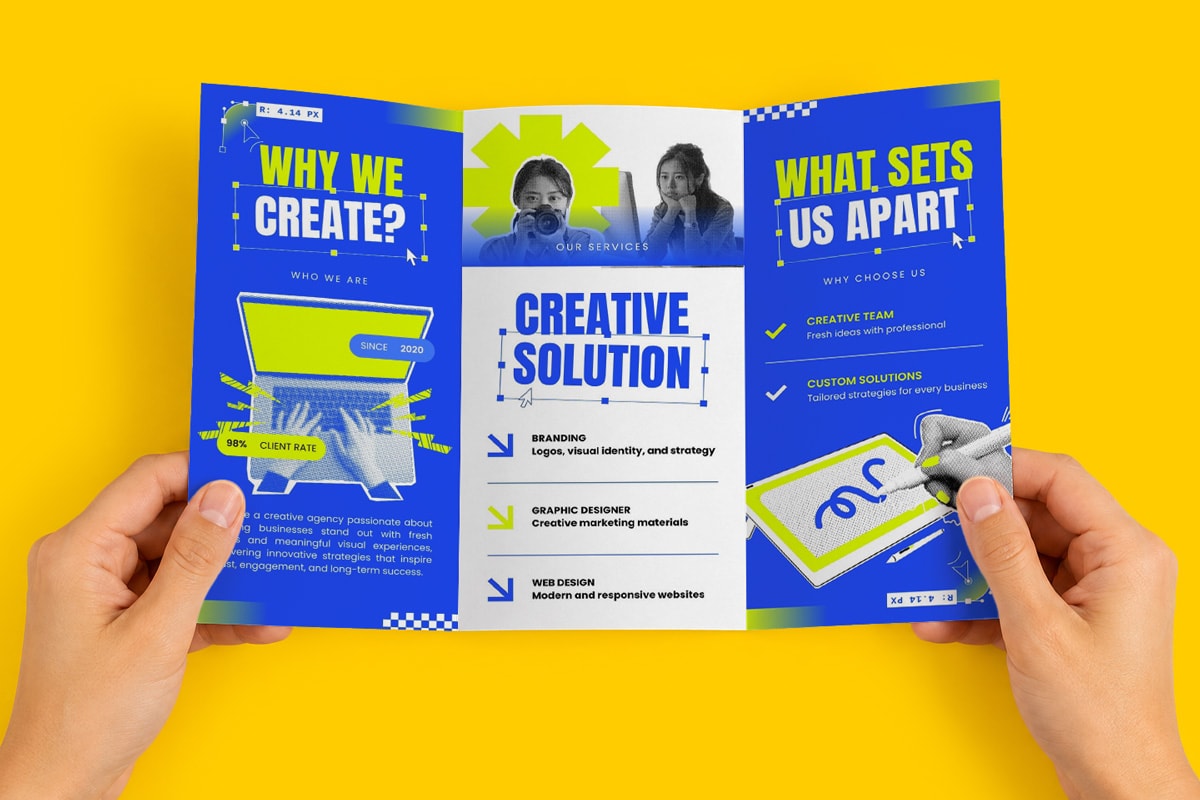 Hands holding a tri-fold brochure about creative agency services.