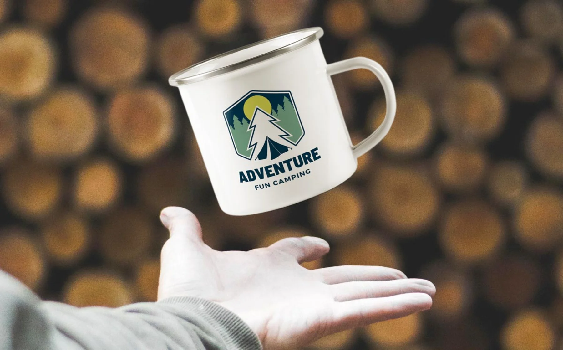 A person holding a mug that features the word "adventure" prominently displayed on its surface