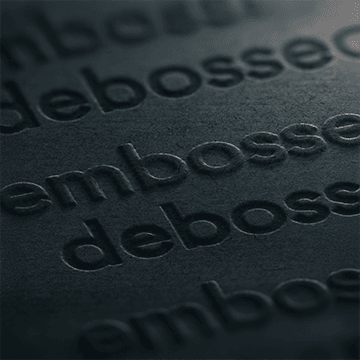 A matt black sheet showcasing both embossing and debossing with words imprinted