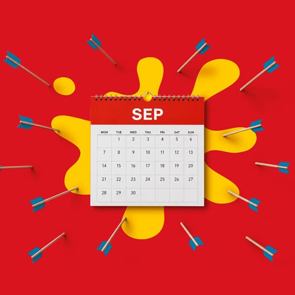 September calendar on red background with blue arrows and a yellow splash design.