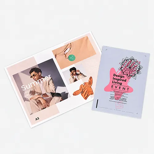 Two printed flyers on a light surface; one advertises "Summer," the other a design event.
